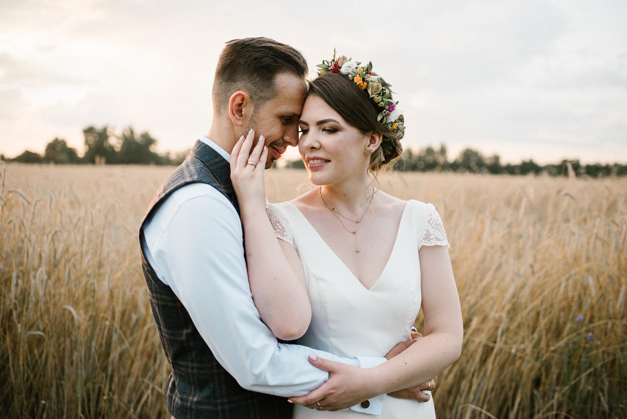 Para młoda patrzy sobie w oczy na polu - sesja ślubna w plenerze Poznań