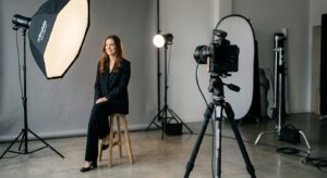 A professional editorial shot of a minimalist photography studio setup featuring a high-end camera o